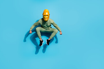 Photo of strong fit energetic guy jump intimidate pose wear chimpanzee mask sportswear isolated blue color background
