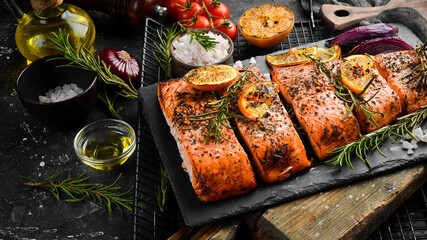 Baked Salmon with rosemary, lemon and vegetables. Recipe. Seafood. Side view Free space for text.