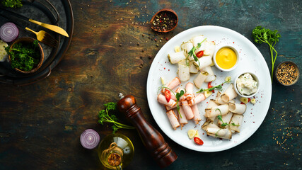 Slicing lard with pepper and salt. Ukrainian traditional cuisine. Top view. Rustic style.