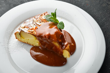 Dessert. Biscuit apple pie with caramel topping on a plate. Top view.