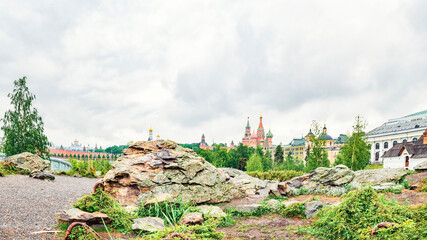 Huge stone, grass and lichen in the center of Moscow in Zaryadye Park against the background of...