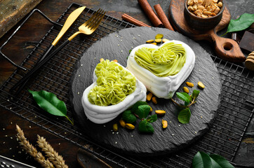 Pavlov's dessert. Bizet cakes with pistachio cream. Sweets. Top view. Rustic style.