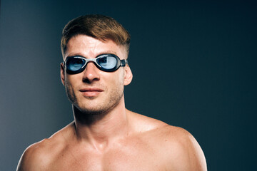 sports man with naked torso swimmer professional dark background
