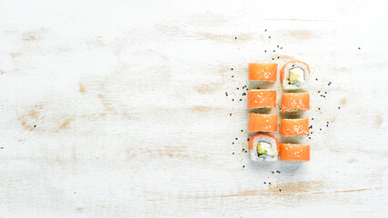 Philadelphia sushi roll with salmon and avocado. Japanese Traditional Cuisine. Top view. Rustic style.