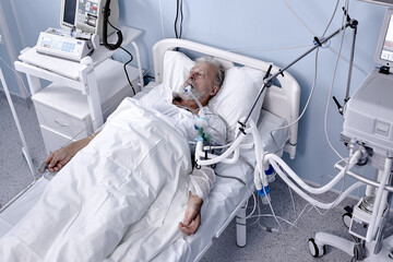 sick senior caucasian man has blood transfusion in hospital, patient with tube in mouth. ill male...