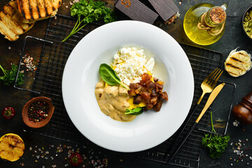 Banosh with mushrooms, bacon and brynza cheese on a plate. Hungarian traditional cuisine. Top view.
