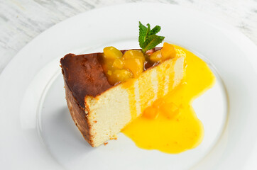 Dessert. Cheesecake with fruit topping on a plate. Top view.