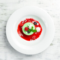 Dessert. Mint panna cotta with ice cream on a plate. Top view.