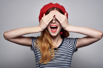 cheerful woman in a striped t-shirt red lips gesture with his hands lifestyle