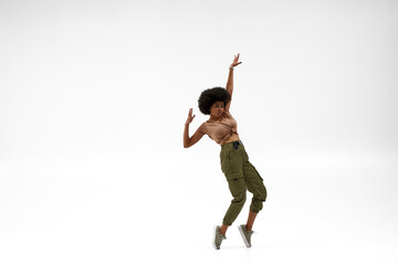 Black woman dancing hip hop on white background