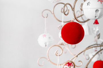 Red velvet Christmas bauble and white ornaments in metallic tree