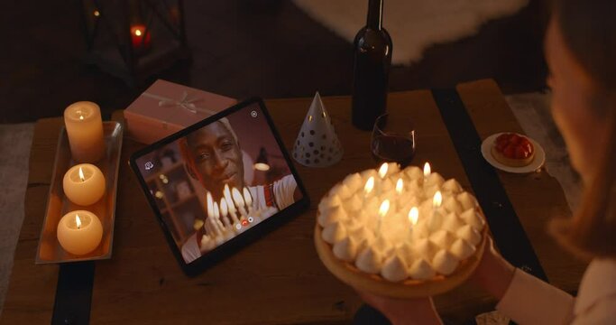 Mixed race couple having online celebration of birthday