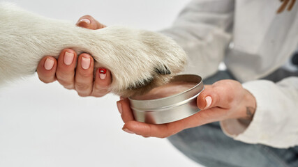 Woman putting paw of dog in wax pet paw print