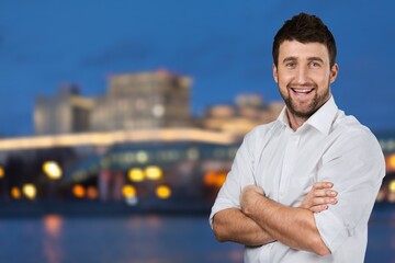 Portrait of Handsome Man Smiling, Looking at Camera, Standing in Night City with Bokeh