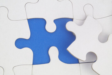 Obraz premium White jigsaw puzzles background, one piece missing and ready to connecting. Business strategy, teamwork, problem solving and complete mission concept. 