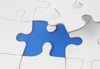 Fototapeta premium White jigsaw puzzles background, one piece missing and ready to connecting. Business strategy, teamwork, problem solving and complete mission concept. 