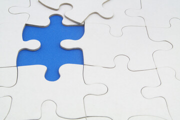 Fototapeta premium White puzzles background, one piece missing and ready to connecting. Business strategy, team work, problem solving and complete mission concept. 