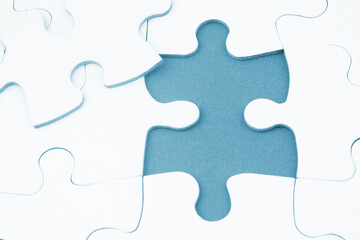 Obraz premium White jigsaw puzzles background, one piece missing and ready to connecting. Business strategy, teamwork, problem solving and complete mission concept. 