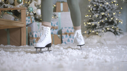 Happy young woman skates on ice rink