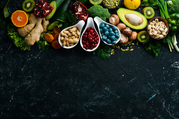 Obraz na płótnie Canvas Healthy food. Vegetables and fruits. On a black wooden background. Top view. Copy space.