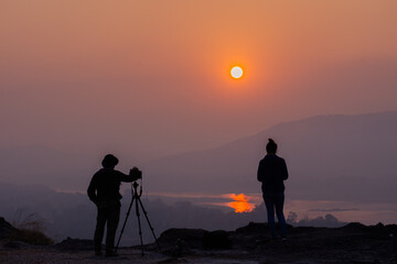 silhouette of a person with a camera