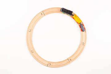 Circle wooden railway and toy train on white background. Top view, copy space for text
