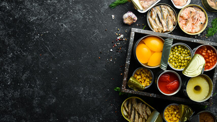 Food stocks. Food in tin cans. Vegetables, fruits, fish, meat and legumes are marinated in jars.