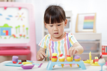 young girl making  food using dough tools  for homeschooling