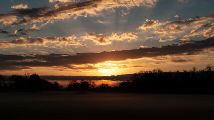 Fototapeta na wymiar Beautiful sunrise with cloudscape sunbeams and fog