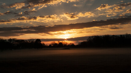 Fototapeta na wymiar Beautiful sunrise panorama with cloudscape, sunbeams and fog