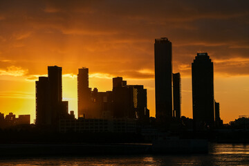 Sunrise in New York with dramatic sky and view to the tall skyscraper office buildings. Amazing color vibe. View to Astoria neighbourhood. Travel to America.