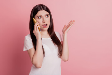 Photo of young beautiful girl unhappy upset angry mad talk cellphone conversation isolated on pink color background