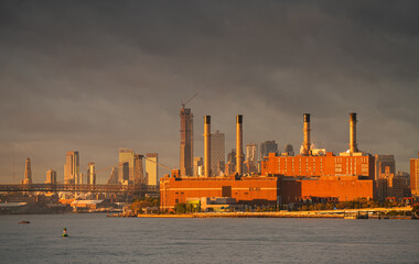 Sunrise in New York with dramatic sky and view to the tall skyscraper office buildings. Amazing...