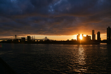 Sunrise in New York with dramatic sky and view to the tall skyscraper office buildings. Amazing color vibe. View to Astoria neighbourhood. Travel to America.