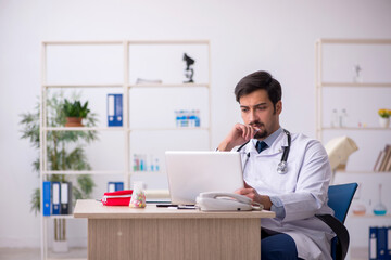 Young male doctor in telemedicine concept