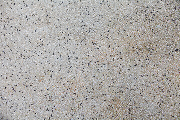 Cement mixed small gravel stone wall or floor texture background,The Dust Texture. Abstract dense splash texture. Random pebble gravel oval elements seamless pattern.