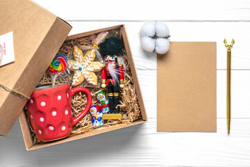 Handmade care package, seasonal gift box with candies, cup on white table Personalized eco friendly basket for family, friends, girl for thanksgiving, xmas, Christmas, mothers, fathers day Flat lay