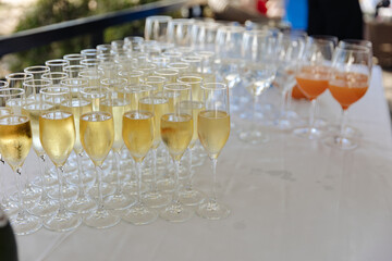 Lots of wine glasses during some festive event 