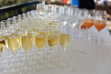 Lots of wine glasses during some festive event 