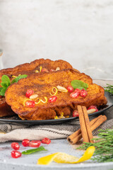 Traditional Christmas Rabanadas with lemon zest, pomegranate, pine nuts and cinnamon. Spanish...