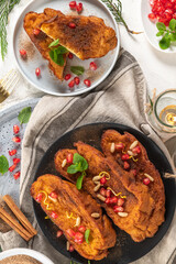 Traditional Christmas Rabanadas with lemon zest, pomegranate, pine nuts and cinnamon. Spanish...