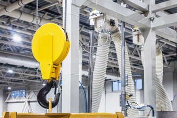 Crane hook inside factory building, industrial