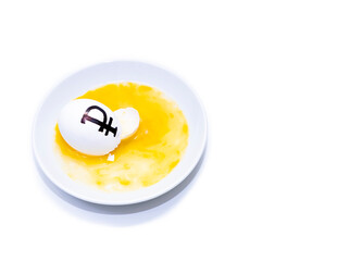 A broken egg with the Russian ruble symbol lies on a plate, copy space.