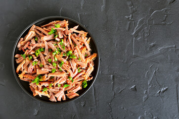Slow cooked pulled beef for sandwiches with parsley on  plate