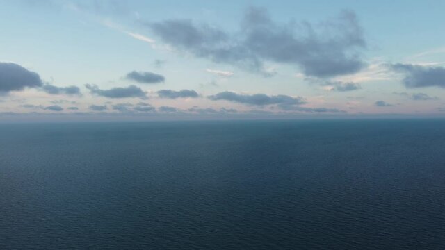 Black sea coast at sunset, blue waves white sand, sunset