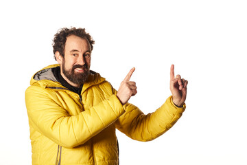 Fototapeta premium Bearded man in outerwear pointing away with two finger