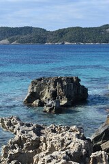 Fototapeta premium Rocks, the sea and mountains in a National Park called Las Salinas in Ibiza