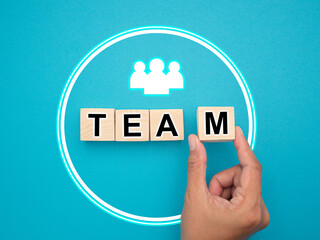 Team and teamwork concept. Hand holding wooden cube elements with letters 