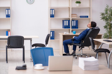 Young male employee and too much work in the office