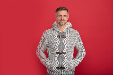 hair and skin care. grizzled guy in sweater on red background. hoary man portrait.